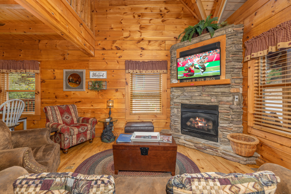Fireplace and TV at Livin' Simple, a 2 bedroom cabin rental located in Pigeon Forge