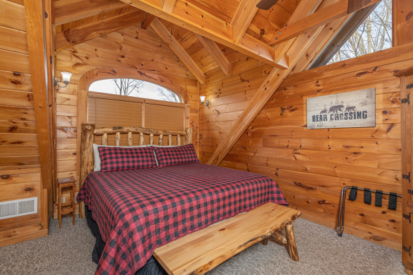 Loft with king bed, bench, and luggage rack at Livin' Simple, a 2 bedroom cabin rental located in Pigeon Forge 