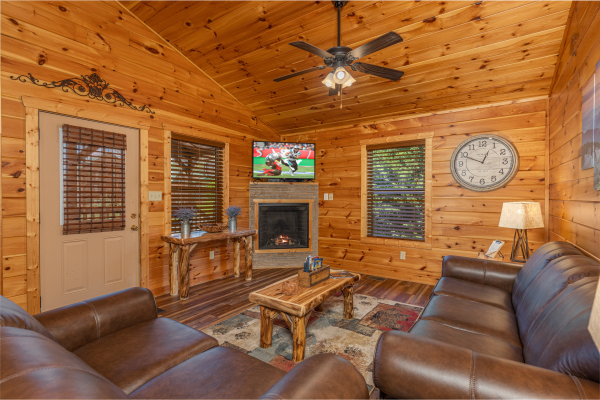 Living room with fireplace and TV at Pinot Paradise, a 3 bedroom cabin rental located in Pigeon Forge
