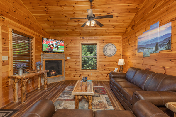 TV and fireplace in a living room at Pinot Paradise, a 3 bedroom cabin rental located in Pigeon Forge