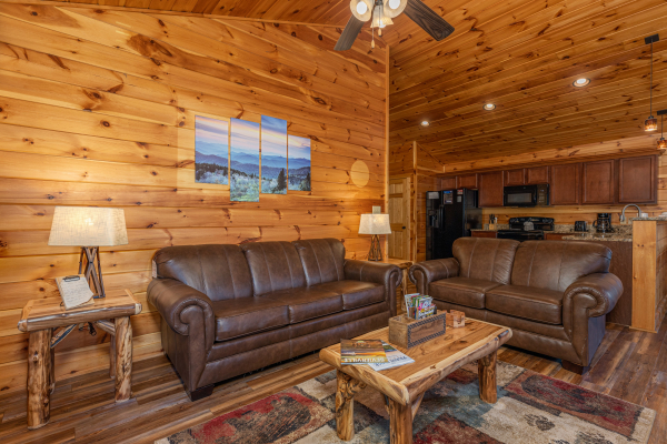 Loveseat and sofa in a living room at Pinot Paradise, a 3 bedroom cabin rental located in Pigeon Forge