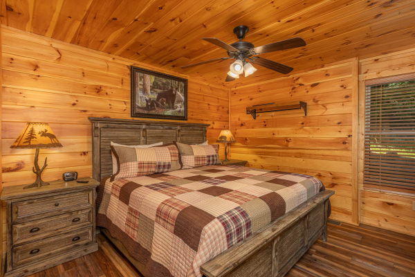 Bedroom with a king bed, two night stands, and two lamps at Pinot Paradise, a 3 bedroom cabin rental located in Pigeon Forge