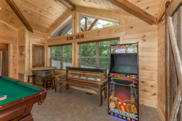 Arcade game in the game room at Sawmill Springs, a 3 bedroom rental cabin in Pigeon Forge