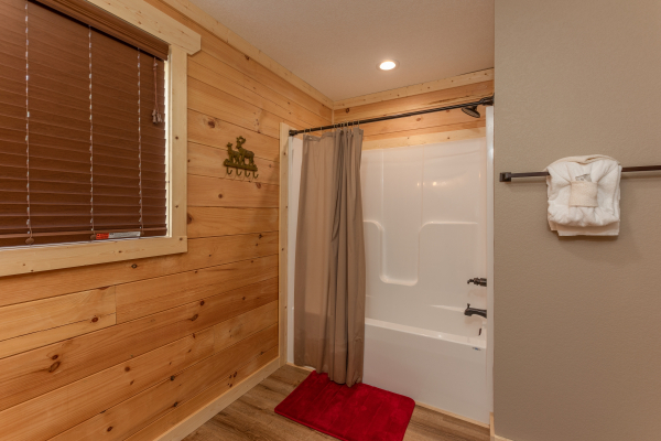 Bathroom with a tub and shower at Sawmill Springs, a 3 bedroom cabin rental located in Pigeon Forge