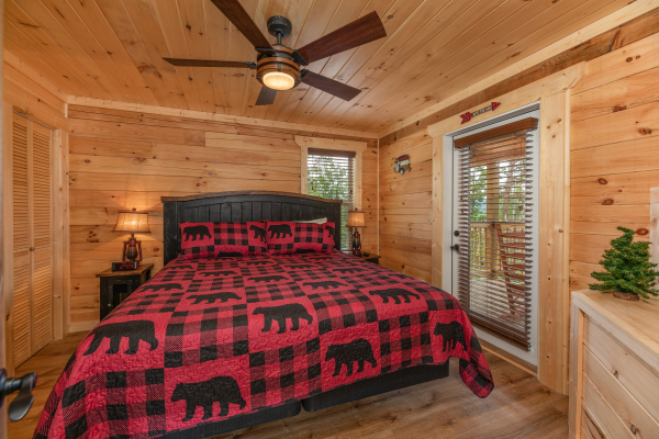 King bed and deck access in a bedroom at Sawmill Springs, a 3 bedroom cabin rental located in Pigeon Forge