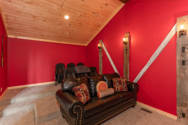 Sofa and movie seats in the home theater at Sawmill Springs, a 3 bedroom rental cabin in Pigeon Forge