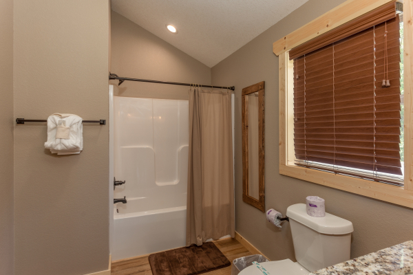 Bathroom with tub and shower at Sawmill Springs, a 3 bedroom rental cabin in Pigeon Forge