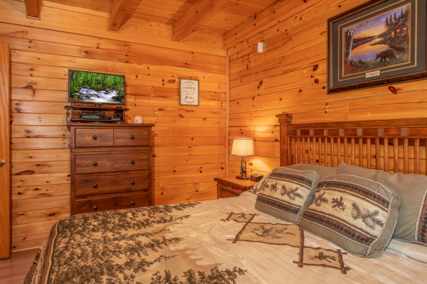 King bedroom with dresser and TV at Grand View, a 3 bedroom cabin rental located in Sevierville