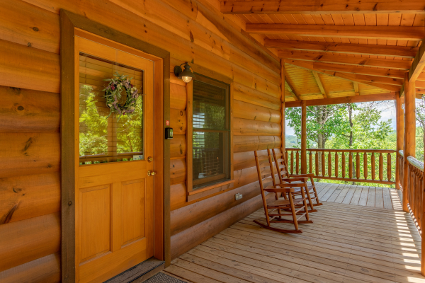 Front porch with rocking chairs at Mountain Adventure, a 2 bedroom cabin rental located in Pigeon Forge