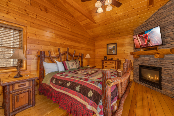 Master bedroom with fireplace and TV at Mountain Adventure, a 2 bedroom cabin rental located in Pigeon Forge