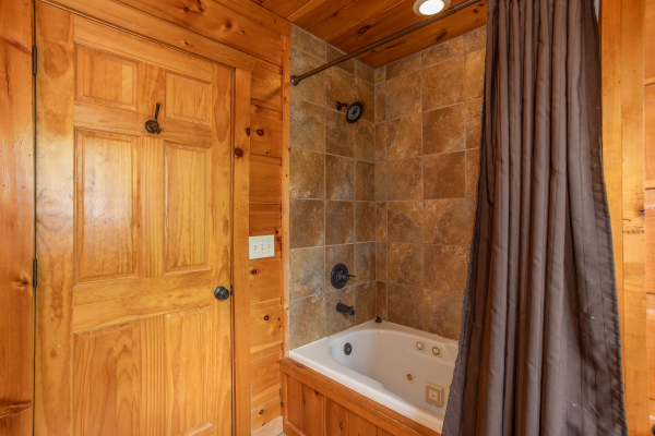 Bathroom with a jacuzzi and shower at Mountain Bliss, a 2 bedroom cabin rental located in Pigeon Forge
