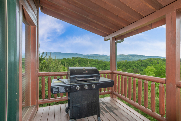 Grill on a covered deck at Mountain Bliss, a 2 bedroom cabin rental located in Pigeon Forge