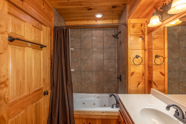 Bathroom with jacuzzi and shower at Mountain Bliss, a 2 bedroom cabin rental located in Pigeon Forge