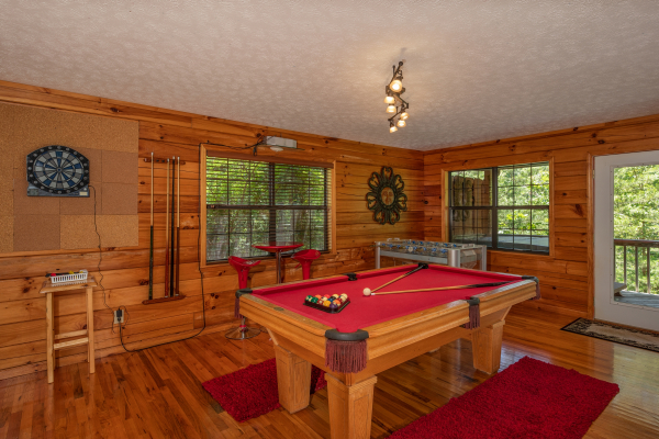 Pool table and dart board at Hello Dolly, a 1 bedroom cabin rental located in Pigeon Forge