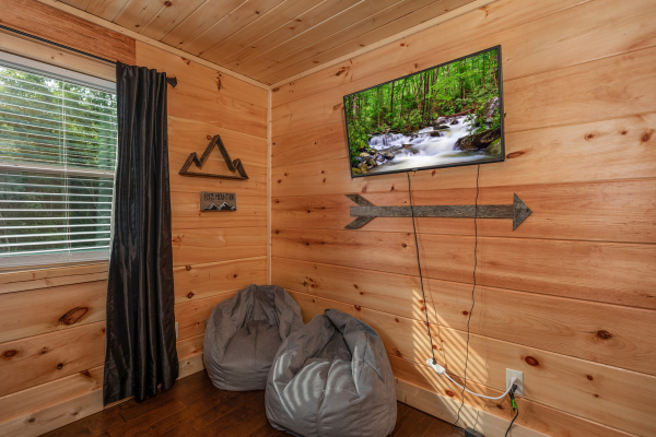 Bean bag chairs and a wall-mounted TV at Always Dream'n, a 6 bedroom cabin rental located in Pigeon Forge