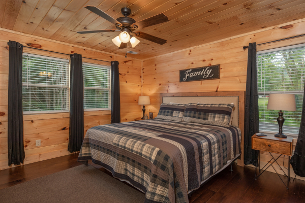 Bedroom with a king bed, two night stands, and two lamps at Always Dream'n, a 6 bedroom cabin rental located in Pigeon Forge