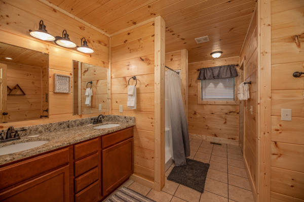 Bathroom with double vanity sinks at Always Dream'n, a 6 bedroom cabin rental located in Pigeon Forge