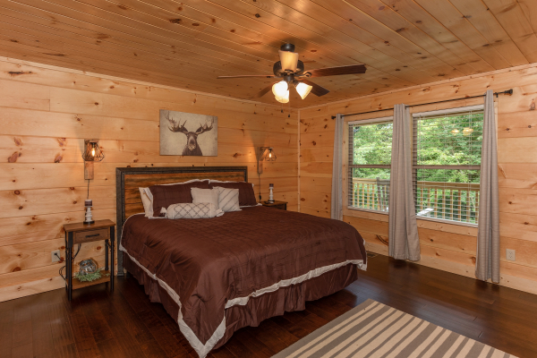 Bedroom with a king bed and two night stands at Always Dream'n, a 6 bedroom cabin rental located in Pigeon Forge