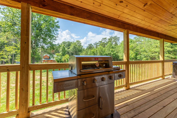 Grill on a covered deck at Always Dream'n, a 6 bedroom cabin rental located in Pigeon Forge