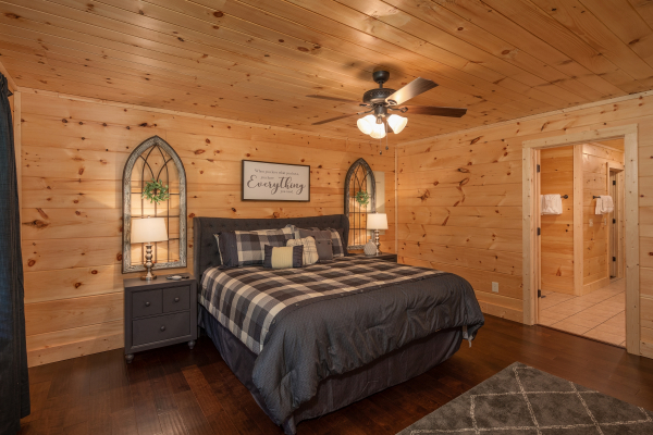 Bedroom with a king bed, two night stands, and two lamps at Always Dream'n, a 6 bedroom cabin rental located in Pigeon Forge