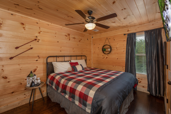 Bedroom with a night table at Always Dream'n, a 6 bedroom cabin rental located in Pigeon Forge