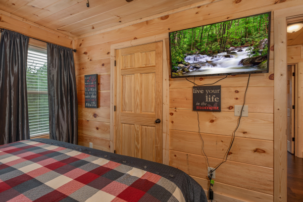 Wall mounted TV in a bedroom at Always Dream'n, a 6 bedroom cabin rental located in Pigeon Forge