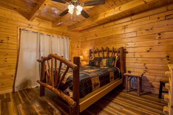Wood Carved Bed at Top Of The Way, a 2 bedroom cabin rental located in pigeon forge