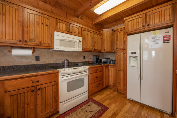 Kitchen with white appliances at Mountain Lake Getaway, a 3 bedroom cabin rental located at Douglas Lake