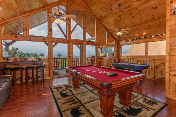 Pool table, bar area, and air hockey table in the loft at 1 Above the Smokies, a 2 bedroom cabin rental located in Pigeon Forge