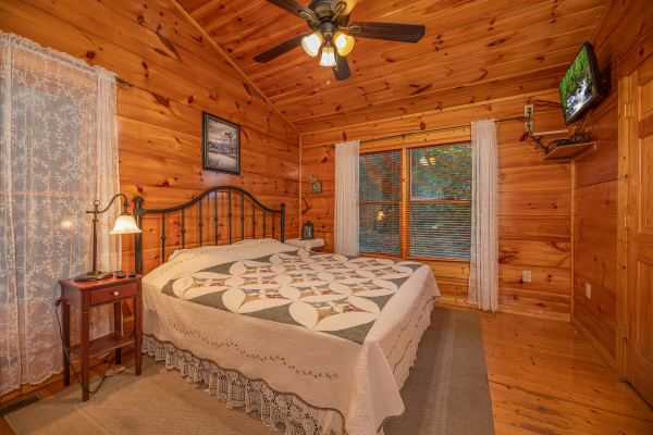 Bedroom with a king bed and TV at Firefly Ridge, a 2 bedroom cabin rental located in Pigeon Forge