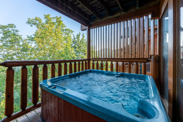 Hot tub with privacy fence at Rocky Top Retreat, a 2 bedroom cabin rental located in Pigeon Forge
