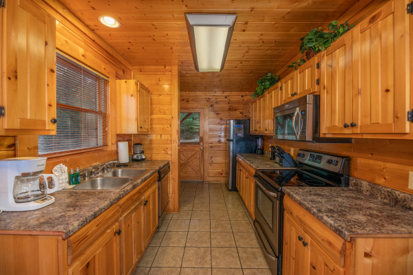 Kitchen with stainless appliances at Rocky Top Retreat, a 2 bedroom cabin rental located in Pigeon Forge