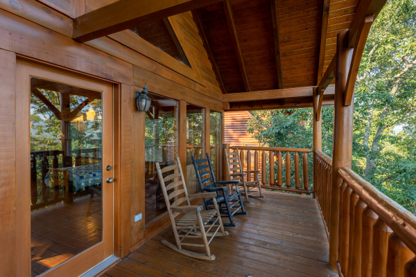 Rocking chairs on the covered deck at Rocky Top Retreat, a 2 bedroom cabin rental located in Pigeon Forge