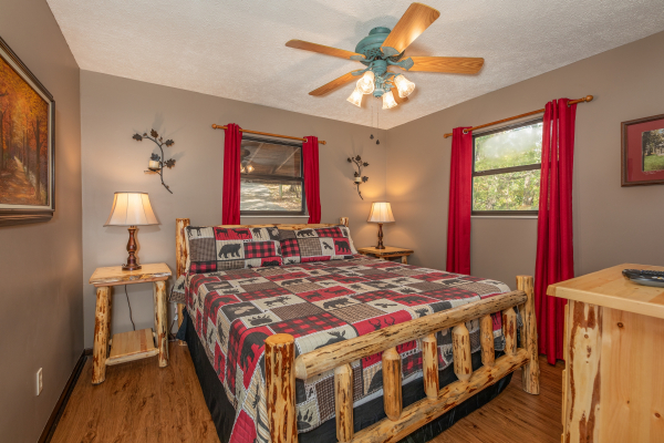 Bedroom with log bed, tables, lamps, and dresser at Misty Mountain Sunrise, a 3 bedroom cabin rental located in Pigeon Forge