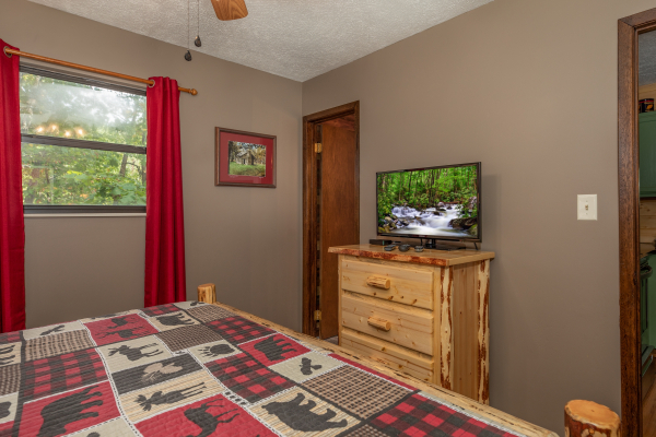 Dresser and TV in a bedroom at Misty Mountain Sunrise, a 3 bedroom cabin rental located in Pigeon Forge