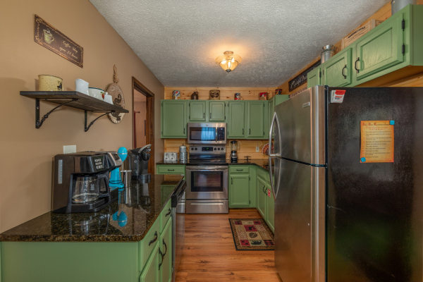Kitchen with stainless appliances at Misty Mountain Sunrise, a 3 bedroom cabin rental located in Pigeon Forge