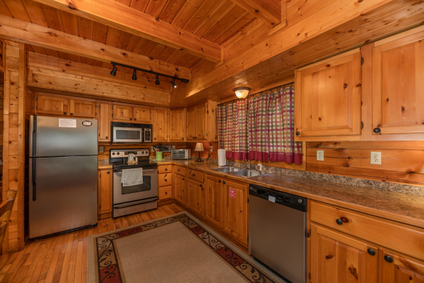 Kitchen with stainless appliances at Majestic Mountain, a 4 bedroom cabin rental located in Pigeon Forge