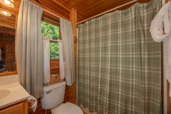 Bathroom with a tub and shower at Majestic Mountain, a 4 bedroom cabin rental located in Pigeon Forge