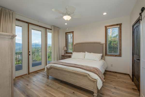 Bedroom with a king bed and night stand at Mountain Celebration, a 4 bedroom cabin rental located in Gatlinburg