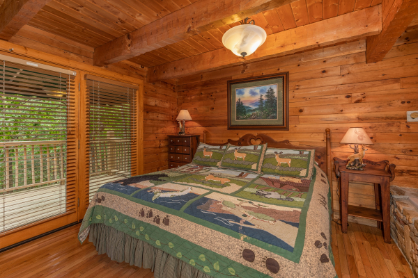 King bed, two night stands, and lamps in a bedroom at Yes, Deer, a 2 bedroom cabin rental located in Pigeon Forge