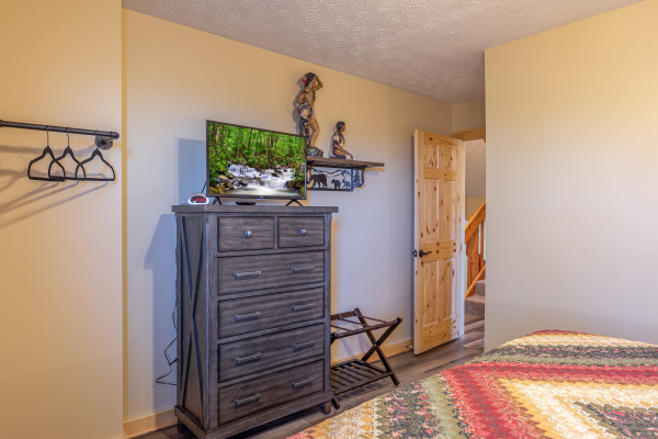 Dresser and TV in a bedroom at Le Bear Chalet, a 7 bedroom cabin rental located in Gatlinburg