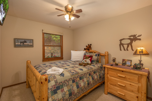 Bedroom with log bed and night stand at Lazy Bear Retreat, a 4 bedroom cabin rental located in Pigeon Forge