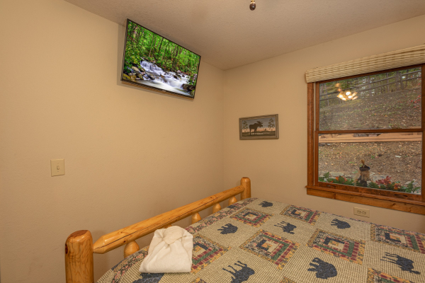 Bedroom with a wall mounted TV at Lazy Bear Retreat, a 4 bedroom cabin rental located in Pigeon Forge