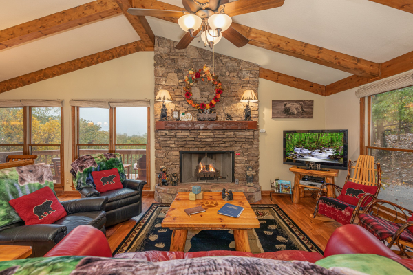 Living room with two recliners, sofa, fireplace, and TV at Lazy Bear Retreat, a 4 bedroom cabin rental located in Pigeon Forge