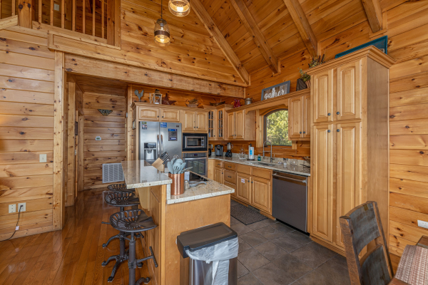 Kitchen with breakfast bar and stainless appliances at Mountain Mama, a 3 bedroom cabin rental located in Pigeon Forge