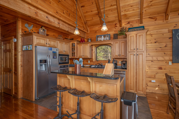 Kitchen with breakfast bar at Mountain Mama, a 3 bedroom cabin rental located in Pigeon Forge