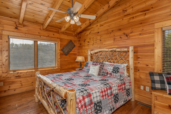 Bedroom with a wood bed at Mountain Mama, a 3 bedroom cabin rental located in Pigeon Forge