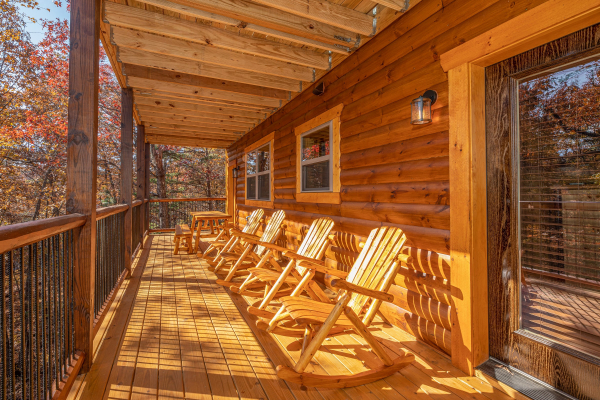 Rocking chairs on a covered porch at Pinot Splash, a 4 bedroom cabin rental located in Gatlinburg