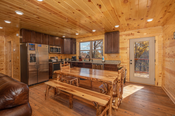 Dining table and kitchen at Pinot Splash, a 4 bedroom cabin rental located in Gatlinburg