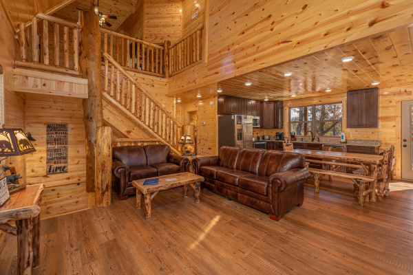 Living room with sofa and loveseat with adjacent dining space at Pinot Splash, a 4 bedroom cabin rental located in Gatlinburg